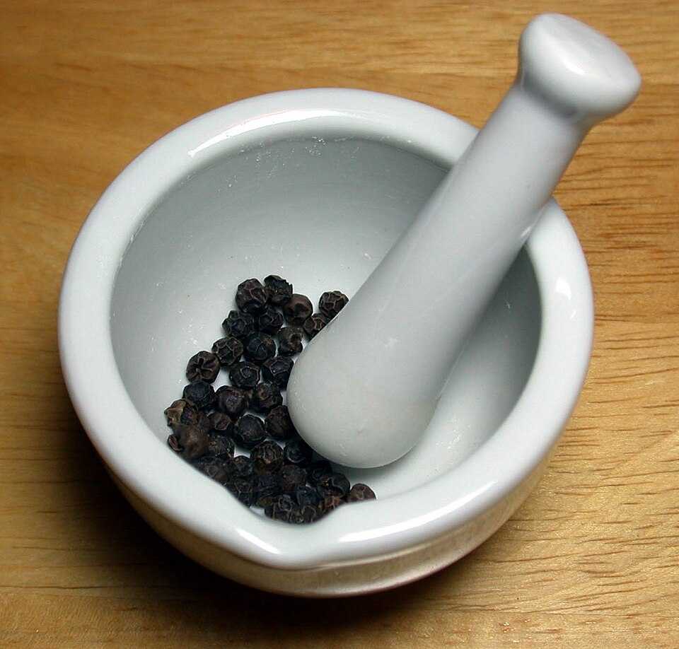 Black peppercorns in a mortar